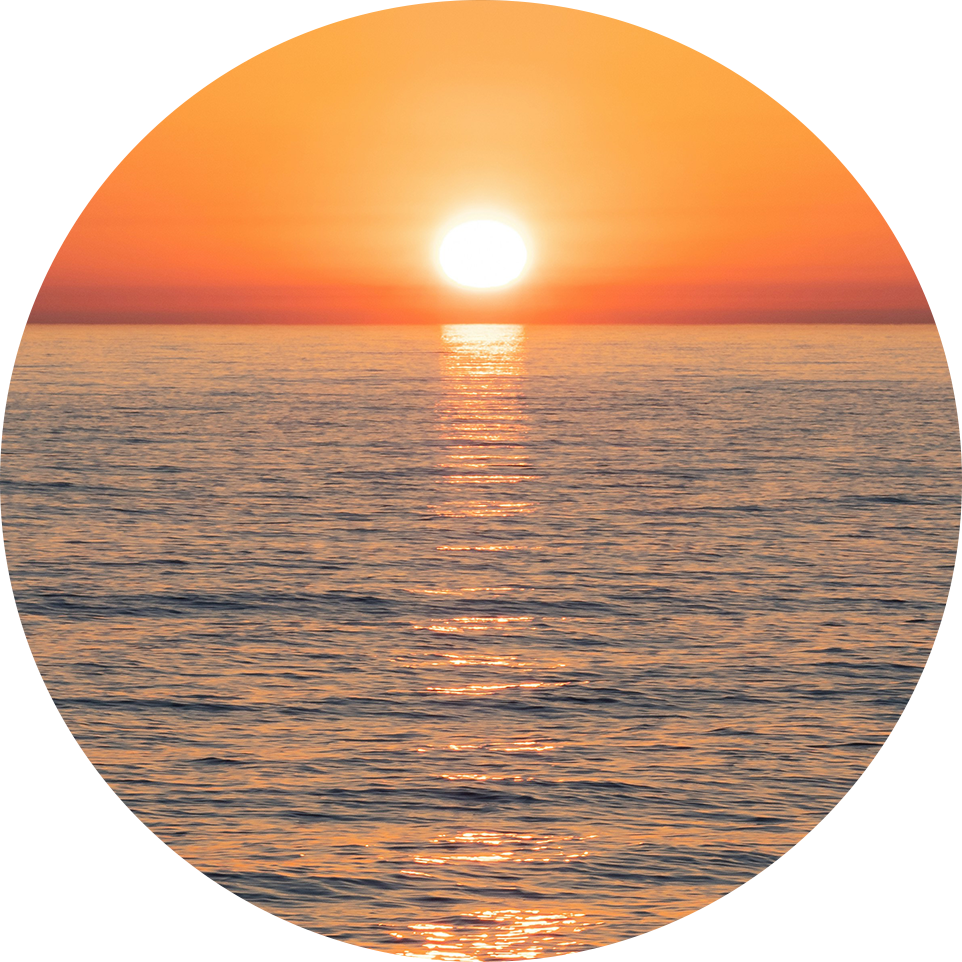 A sunset reflecting over the ocean, with a warm orange glow on the horizon, reflecting the peace and simplicity that can come with direct cremation.